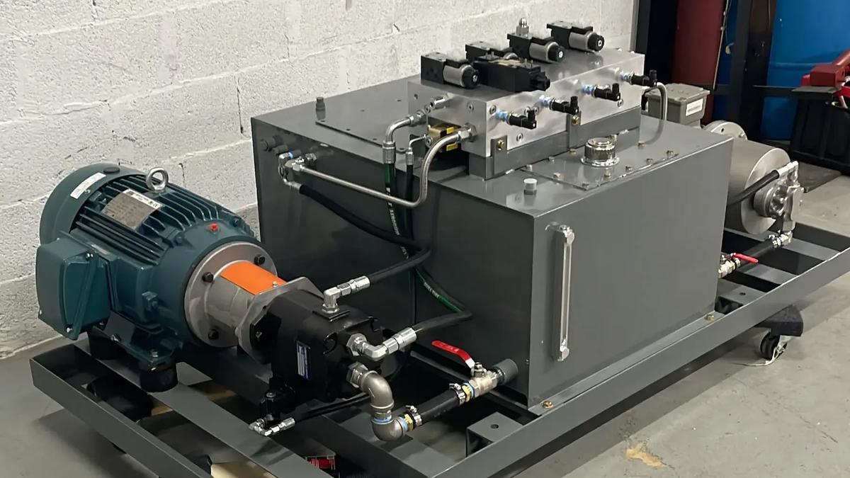 An image of a hydraulic power unit, comprising a substantial metal box and a hose, designed for effective hydraulic energy conversion