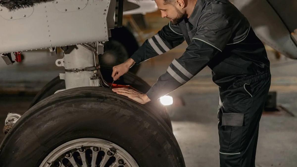 A professional technician performing on-site aviation hydraulic field services