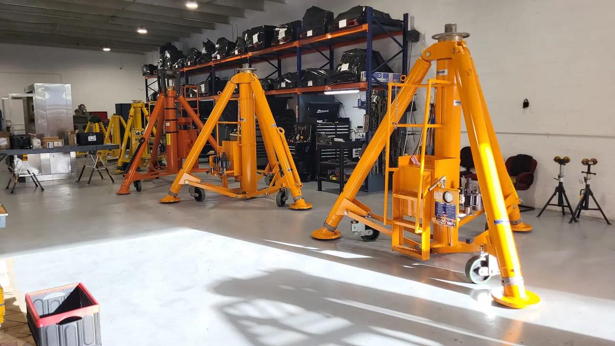 Some big aviation jacks inside a warehouse.